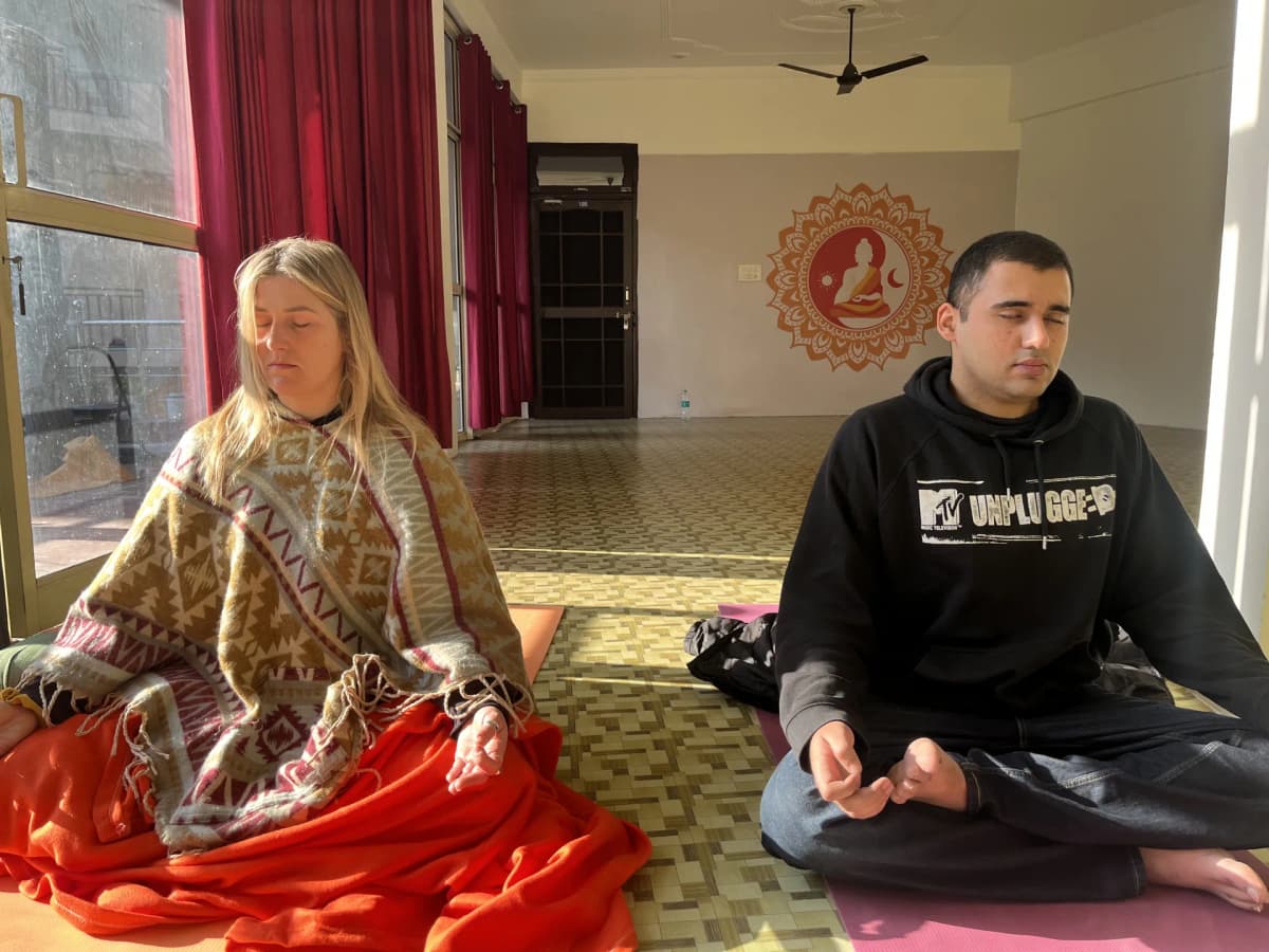 Students studying ancient yoga philosophy texts at Anantadrishti Yoga in Rishikesh